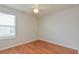 Well-lit bedroom with wood floors and a window with blinds at 2572 Berrington Loop, The Villages, FL 32162