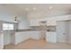 White kitchen with granite countertops and tile flooring at 2572 Berrington Loop, The Villages, FL 32162