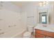 Clean bathroom with tub, toilet, vanity, and mirrored medicine cabinet at 2572 Berrington Loop, The Villages, FL 32162