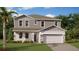 Two-story house with a two-car garage and stone accents at 3168 Armstrong Ave, Clermont, FL 34714