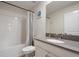 Clean bathroom with shower/tub combo, gray vanity, and white tile at 4550 Narrative Ln, Kissimmee, FL 34746