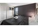 King bedroom with TV and dark accent wall at 4550 Narrative Ln, Kissimmee, FL 34746