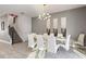 Bright dining room with white chairs and geometric wall art at 4550 Narrative Ln, Kissimmee, FL 34746