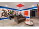 Entertaining game room with mural, sofa, and coffee table at 4550 Narrative Ln, Kissimmee, FL 34746