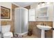 Bathroom with a pedestal sink, toilet and shower stall at 604 N Sinclair Ave, Tavares, FL 32778