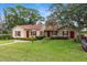 Single story home with red shutters and landscaping at 604 N Sinclair Ave, Tavares, FL 32778