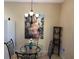 Bright dining area with glass table and four chairs, chandelier, and wall art at 3234 Bonnybrook S Dr, Lakeland, FL 33811