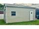 Tan metal garage with window and diamond door at 3234 Bonnybrook S Dr, Lakeland, FL 33811