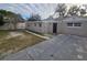 Home's exterior showcasing a brick facade and a small yard at 1124 Sunshine Ave, Leesburg, FL 34748