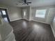 Spacious living room with built-in shelving and hardwood floors at 1124 Sunshine Ave, Leesburg, FL 34748