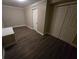 Well-lit bedroom with double door closet and hardwood floors at 1124 Sunshine Ave, Leesburg, FL 34748