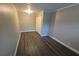 Simple bedroom with dark laminate floors and neutral walls at 1124 Sunshine Ave, Leesburg, FL 34748