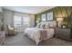 Spacious main bedroom with an olive green accent wall and a plush bed at 1872 Blissful Dr, Kissimmee, FL 34744