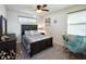 Spacious bedroom with a queen-size bed, dresser, and rocking chair at 2436 Chateau Loop, Kissimmee, FL 34741