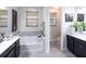 Luxurious bathroom with double vanities, a soaking tub, and a separate toilet area at 2436 Chateau Loop, Kissimmee, FL 34741