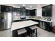 Modern kitchen boasts dark cabinetry, stainless steel appliances, and a large island at 2436 Chateau Loop, Kissimmee, FL 34741