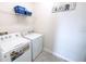 Laundry room with washer, dryer, and shelving at 2436 Chateau Loop, Kissimmee, FL 34741