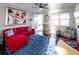 Bright living room features a red sectional sofa and blue rug at 2436 Chateau Loop, Kissimmee, FL 34741