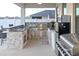 Outdoor kitchen with grill, sink, and refrigerator at 2436 Chateau Loop, Kissimmee, FL 34741