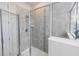 Large walk-in shower with gray tile and glass enclosure at 2436 Chateau Loop, Kissimmee, FL 34741