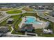 Aerial view of community pool, playground, and parking at 3692 Diving Dove Ln, Bartow, FL 33830