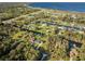 Aerial view of a residential neighborhood near a lake at 6294 Arborea Dr, Indian Lake Estates, FL 33855