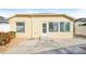 Exterior view of a yellow house with a sunroom and ramp access at 2294 Trailwinds Ter, The Villages, FL 32162