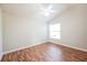 Well-lit bedroom with laminate flooring and a ceiling fan at 2294 Trailwinds Ter, The Villages, FL 32162