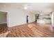 Open concept living area with wood-look floors and views into the kitchen at 2294 Trailwinds Ter, The Villages, FL 32162