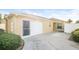 Single-car garage with driveway and landscaping at 2294 Trailwinds Ter, The Villages, FL 32162