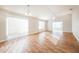 Bright and spacious living room with wood-look flooring and lots of natural light at 2294 Trailwinds Ter, The Villages, FL 32162