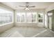Bright sunroom with multiple windows and ceiling fan at 2294 Trailwinds Ter, The Villages, FL 32162