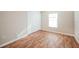 Bright bedroom featuring light wood laminate flooring and a spacious closet at 2294 Trailwinds Ter, The Villages, FL 32162