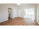 Bedroom with wood flooring and access to a private bathroom and patio at 2294 Trailwinds Ter, The Villages, FL 32162