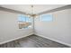 Bright bedroom with wood-look floors, a window, and a modern chandelier at 13126 Stanthorne Ave, Orlando, FL 32832