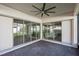 Covered patio with sliding glass doors leading to backyard and kitchen view at 13126 Stanthorne Ave, Orlando, FL 32832