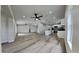 Open concept living room with kitchen views and hardwood floors at 1646 Center St, Deland, FL 32720
