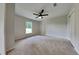 Bright bedroom with neutral walls, ceiling fan, and carpet flooring at 1646 Center St, Deland, FL 32720