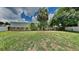 Large grassy backyard with a wooden fence at 1646 Center St, Deland, FL 32720