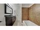 Updated bathroom with brown tile, granite vanity, and a bathtub at 1646 Center St, Deland, FL 32720