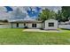 Rear view of the house showcasing a patio and lawn at 1646 Center St, Deland, FL 32720