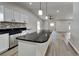 Modern kitchen island with granite countertop and pendant lighting at 1646 Center St, Deland, FL 32720