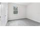 Spacious bedroom with grey carpet and a window at 10560 Sw 49Th Avenue Rd, Ocala, FL 34476