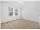 Bright bedroom with neutral carpeting and two large windows at 4970 Sw 106Th St, Ocala, FL 34476