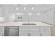 Kitchen island with sink, dishwasher and white cabinetry at 4970 Sw 106Th St, Ocala, FL 34476