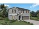 Two-story house with gray siding, brown roof, and a two-car garage at 2242 Old Mining Rd, Lakeland, FL 33801