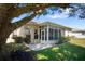 Home exterior showcasing a screened patio and lush landscaping at 5761 Macaw Pl, Lakeland, FL 33809