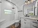 Modern bathroom with white vanity, marble countertop, and walk-in shower at 716 W 14Th St, Lakeland, FL 33805