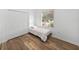 Small bedroom with a single bed and closet, featuring wood flooring at 716 W 14Th St, Lakeland, FL 33805