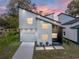 Modern two-story house with white siding and a dark gray accent wall, a landscaped yard and driveway at 716 W 14Th St, Lakeland, FL 33805